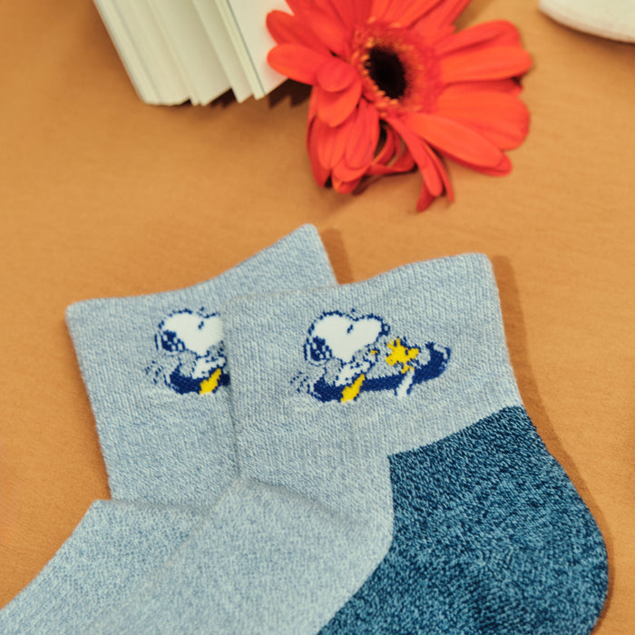 Light blue and denim marl quarter compression socks with a Snoopy canoe design, shown flat.