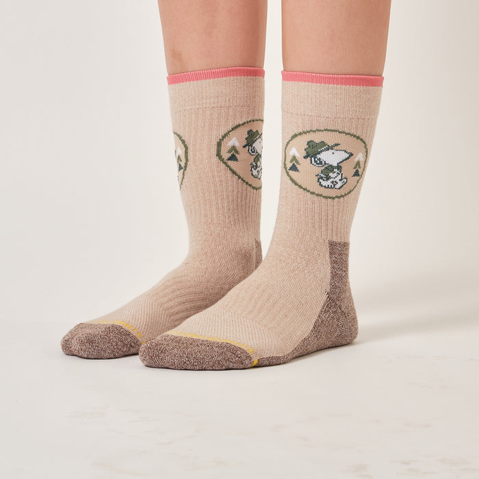 Ivory oat marl crew compression socks with a Beagle Scouts badge design, worn in an outdoor setting.