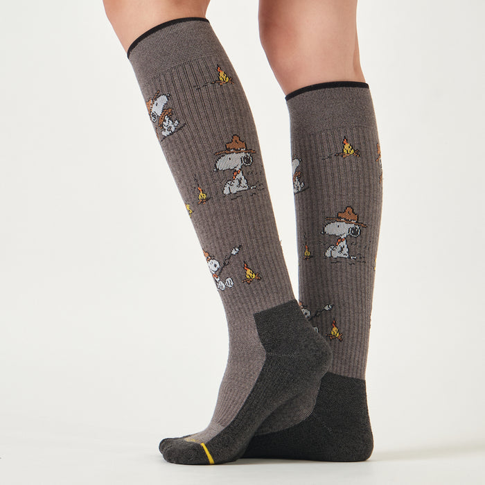 Light grey marl knee-high compression socks with a Snoopy campfire design, worn in a lifestyle setting.