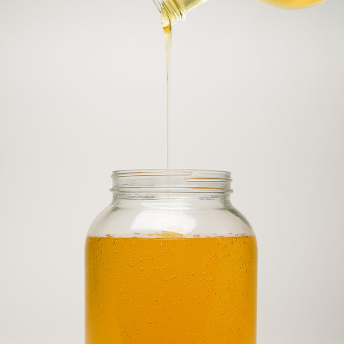 Rustic Strength | Castile Soap - Ultra Concentrate | Unscented being poured in to a jar