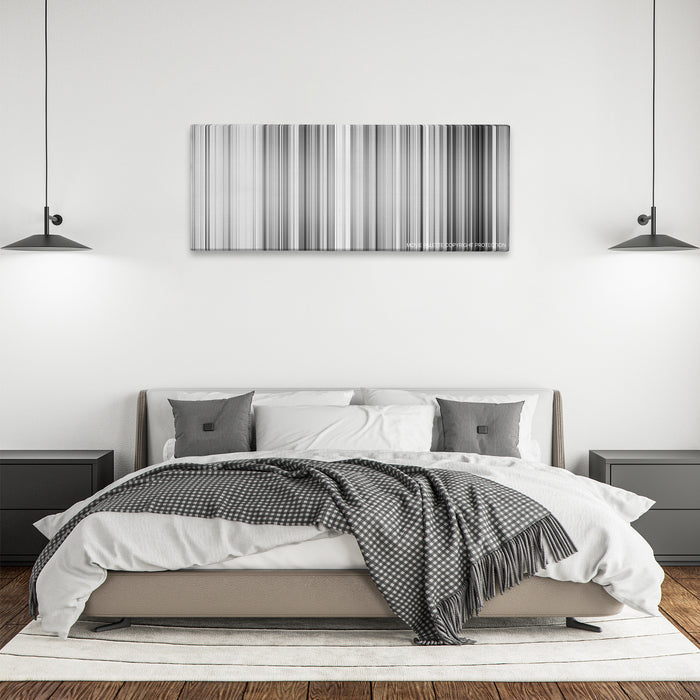 High and Low color palette canvas above a bed, between two black pendant lamps