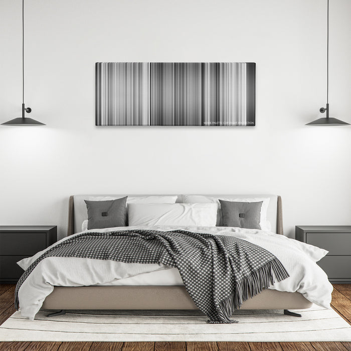 Sherlock Jr. color palette canvas above a bed, between two black pendant lamps