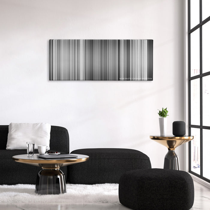 Sherlock Jr. color palette canvas above a black sofa with a gold-topped table