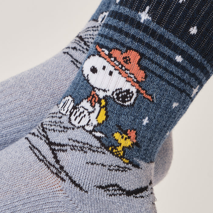 Light blue marl crew compression socks with a Snoopy starry night design, worn in a lifestyle setting.