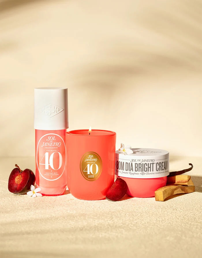 Sol de Janeiro Cheirosa '40' scented candle in a sleek glass jar with a warm, inviting glow and floral design.